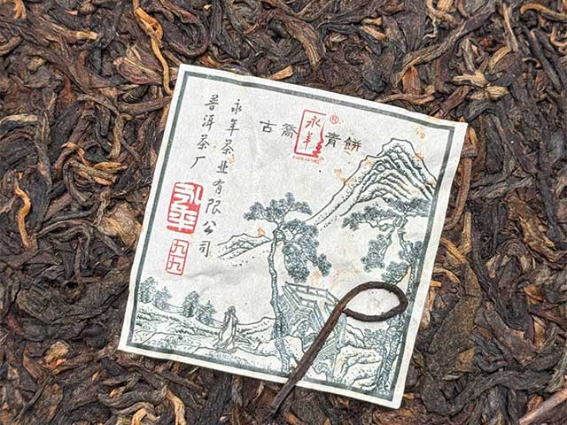 图为普洱茶厂永年九九绿古乔青饼